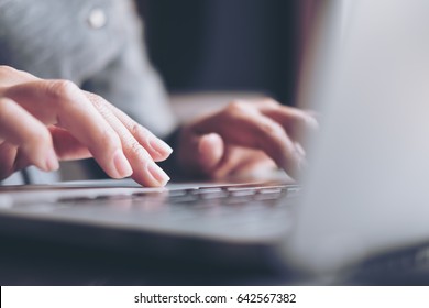 Closeup image of a business woman's hands working and typing on laptop keyboard on glass table - Shutterstock ID 642567382
