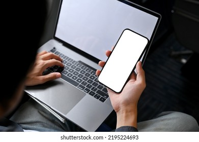 Close-up Image, A Businessman Is On A Flight For His Business Trip, Using His Portable Laptop And Smartphone On The Plane. Phone White Screen Mockup.