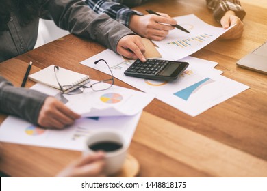 Closeup image of a businessman using calculator in a business meeting - Shutterstock ID 1448818175