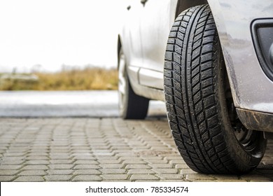 Close-up image of car wheel with black rubber tire