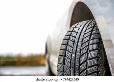 Close-up image of car wheel with black rubber tire