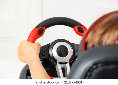 Close-up Image Of The Children's Hands On Pc Gaming Wheel View From Behind