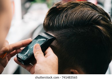 Close-up image of client having his hair done at barbershop