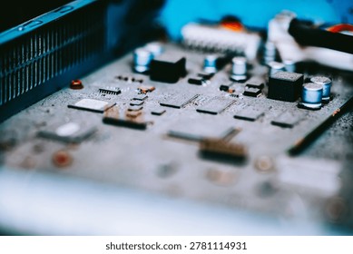 Close-up image of a computer circuit board featuring various microchips, capacitors, resistors, and electronic components used in modern technology and electronic devices.