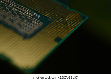 A close-up image of a computer CPU Advanced computing, focusing on the detailed array of gold-colored contact pins and the intricate grid pattern on the processor’s surface.