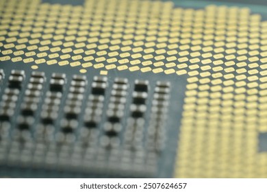 A close-up image of a computer CPU Engineering marvel, focusing on the detailed array of gold-colored contact pins and the intricate grid pattern on the processor’s surface.