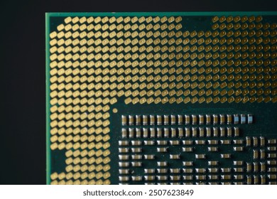 A close-up image of a computer CPU  Information technology, focusing on the detailed array of gold-colored contact pins and the intricate grid pattern on the processor’s surface.