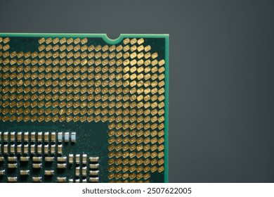 A close-up image of a computer Integrated circuit, focusing on the detailed array of gold-colored contact pins and the intricate grid pattern on the processor’s surface.