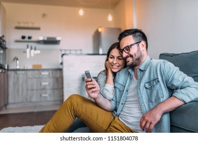 Close-up image of couple watching at smartphone screen indoors. - Powered by Shutterstock