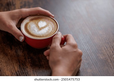 Close-up image of a cup of coffee held in hands. Nothing like a good coffee to start the day. Hand-roasted coffee, authentic coffee. A dose of caffeine. Portrait - Powered by Shutterstock