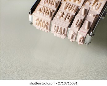 A close-up image of a date stamp with adjustable rubber wheels, featuring months, days, and years.