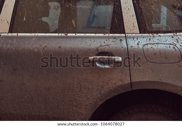 Close-up image of a dirty car after a trip\
around the countryside