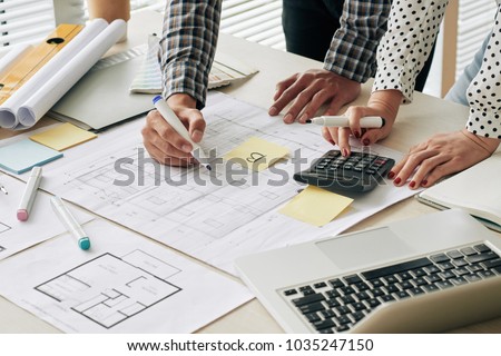 Close-up image of engineers counting estimate cost of constrution project
