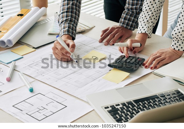 Close-up image of engineers counting estimate\
cost of constrution\
project