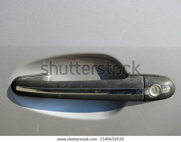 Close-up image\
of an exterior car pull type door handle with lock mounted on the\
side door of a silver color\
automobile