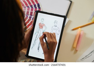 Closeup Image Of Female Artist Coloring Fashion Sketch On Tablet Computer