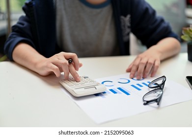 Close-up Image, Female College Student Using Calculator, Doing Her Financial Homework Assignment.