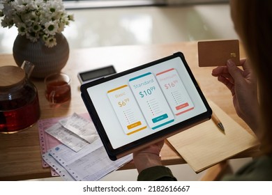 Closeup image of female customer paying for service subscription with credit card