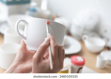 Close-up Image of female hands working with clay mug and making Ceramic Product. Professional Ceramic Artist makes handcrafted products. Small business and hobby concept - Powered by Shutterstock