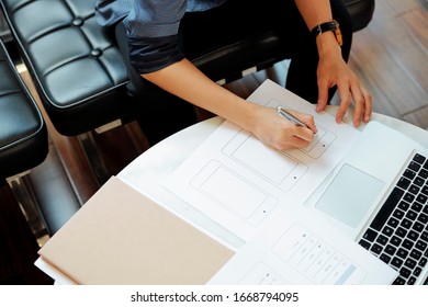 Close-up Image Of Female UX Designer Drawing Mockup Of Mobile Application For New Product