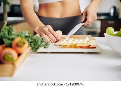 Close-up Image Of Fit Young Woman Putting Fruit Slices On Plate When Making Healthy Appetizer