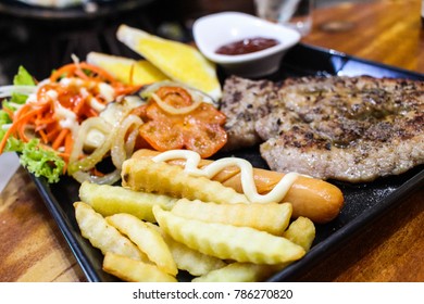 close-up image of french fries and side dish, pork steak - Shutterstock ID 786270820