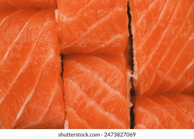 A close-up image of freshly made salmon sushi rolls. - Powered by Shutterstock