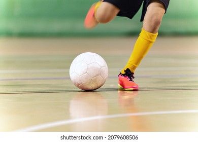 Close-up Image of Futsal Player Kicking Ball. Indoor Soccer Ball Kick. Indoor Football Equipment. Junior Footballer Running and Kicking Ball