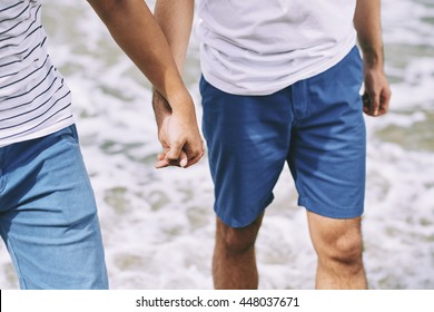 Close-up Image Of Gay Couple Holding Hands When Walking On The Beach