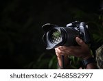 Closeup image of hand holding professional camera 