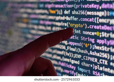 Close-up image of a hand pointing at computer code on a screen related to coding and cybersecurity, with a focus on the interaction between human and digital realms - Powered by Shutterstock - Get 15% off with code: PIKWIZARD15