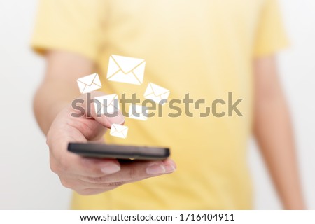 Close-up image hand using smartphone with icon envelope email. Contact us customer service or e-mail marketing concept