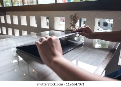Closeup image of hands close and open a laptop computer on table after finished using it