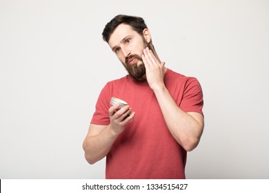 Close-up Image Of Handsome Bearded Man Holding Beard Balm. 