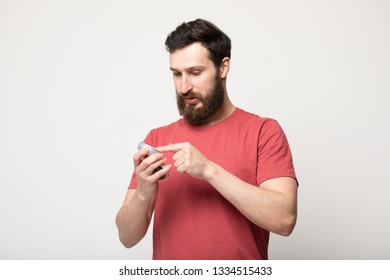 Close-up Image Of Handsome Bearded Man Holding Beard Balm. 