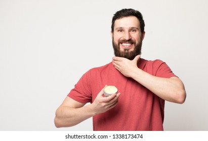 Close-up Image Of Handsome Bearded Man Holding Beard Balm.