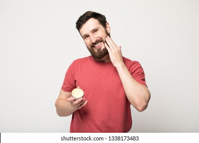 Close-up Image Of Handsome Bearded Man Holding Beard Balm.