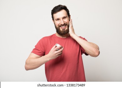 Close-up Image Of Handsome Bearded Man Holding Beard Balm.