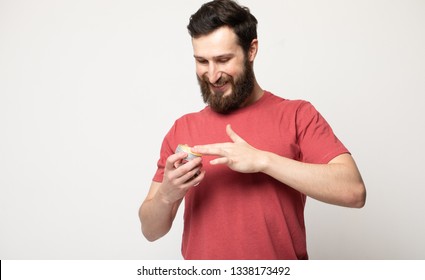 Close-up Image Of Handsome Bearded Man Holding Beard Balm.