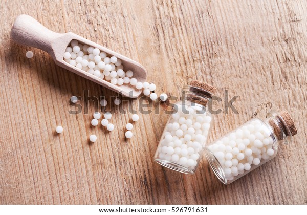 Closeup\
image of homeopathic medicine consisting of the pills and a bottle\
containing a liquid homeopathic\
substance.\
