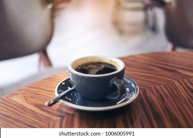 Closeup Image Of Hot Americano Coffee Cup On Vintage Wooden Table In Cafe