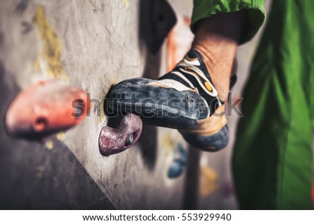 Close-up image of male foot on climbing wall