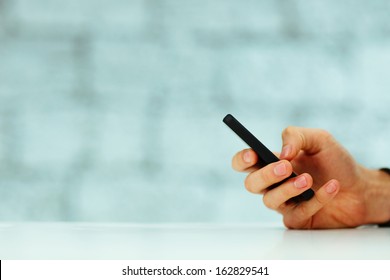 Closeup Image Of A Male Hand Typing On Smartphone