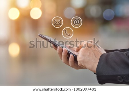 Close-up image of man hands using mobile smartphone with ( mail, phone, email ) icon. Contact us connection and social networks concept