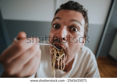 A close-up image of a man humorously devouring spaghetti with a playful expression, highlighting the joy and excitement of eating pasta.
