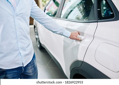 Close-up Image Of Man Opening Back Door Of New Car