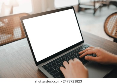 Close-up image of a man sitting in the cafe and using her laptop.  laptop white blank screen mockup for display your graphic banner.