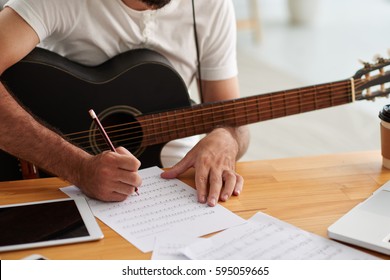 Close-up Image Of Man Writing Music For New Album