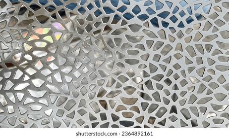 close-up image of a metal plate with a complex grid pattern. Great for use on industrial themed backgrounds, textures or designs.