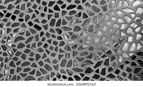 close-up image of a metal plate with a complex grid pattern. Great for use on industrial themed backgrounds, textures or designs.